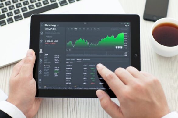 A Man Using Tablet To Analyze The Stocks Of The Company I Itmunch