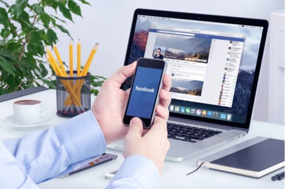 A Man Using Facebook On Mobile I Itmunch