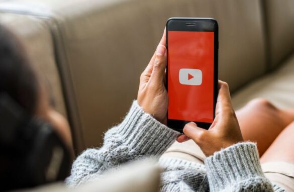 A Youtube User Using The Youtube App On Her Phone